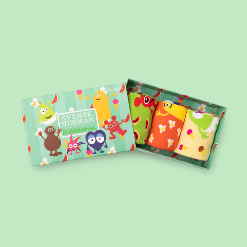 Green gift box containing three pairs of colorful Babblarna kids