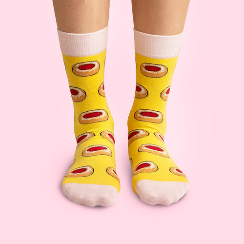 Yellow socks with Swedish raspberry cave cookie patterns from Svenskhusman.
