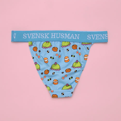 Baby blue tanga thong featuring a Swedish fika pastry pattern and branded waistband on a pink background.
