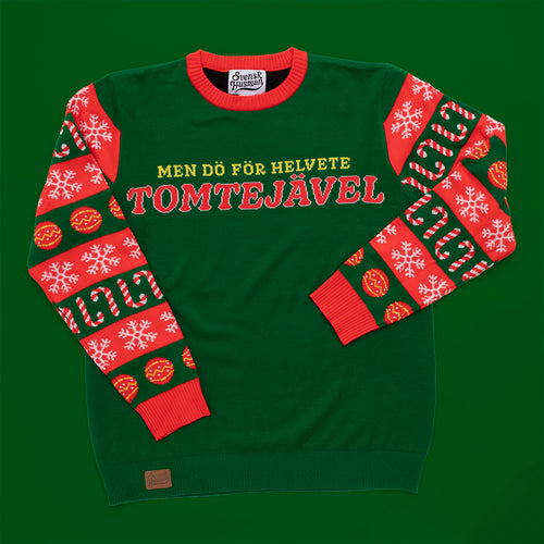 Grøn strikket julesweater med teksten Tomtejävel og mønstrede ærmer i rød fra Svenskhusman.