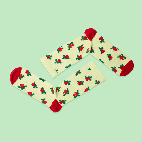 Light yellow compression socks with red lingonberries and red heels from Svenskhusman.