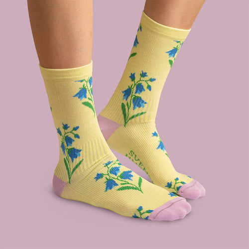Yellow compression socks with bluebell floral patterns and pink heels by Svenskhusman.