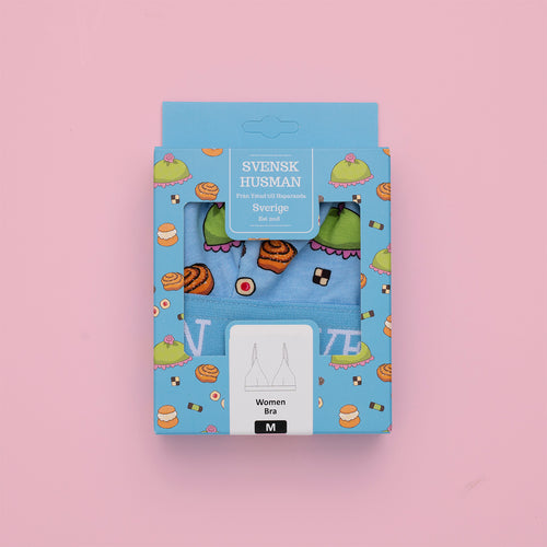 Babyblå BH med fika-mönster i dekorativ förpackning med motiv av bullar och kakor från Svenskhusman.
