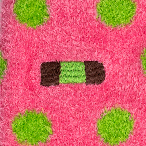 Pink fluffy socks close-up with green dots and a dammsugare punsch roll pattern by Svenskhusman.