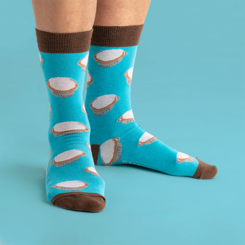 Turquoise Svenskhusman socks featuring a Swedish mazarin pastry pattern and contrasting brown accents.