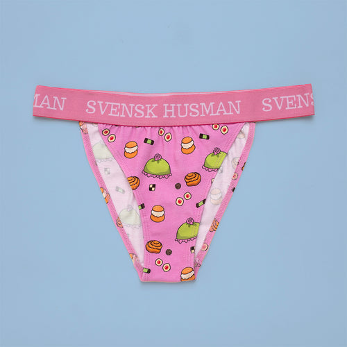 Pink cotton tanga panties with a fika pastry pattern and Svenskhusman branding on the elastic waistband.