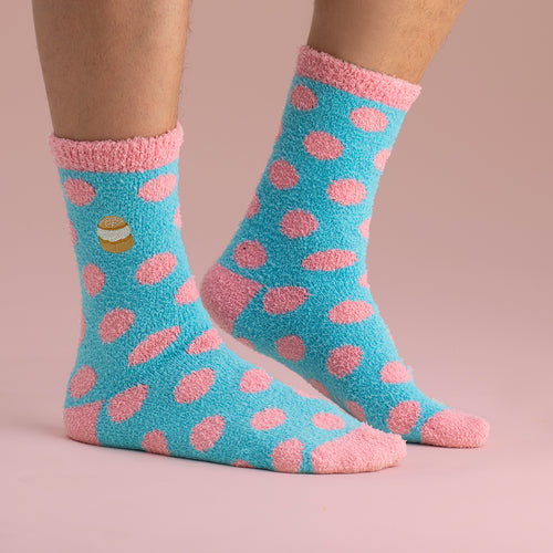Fluffy baby blue socks with pink polka dots and a semla pastry motif from Svenskhusman.