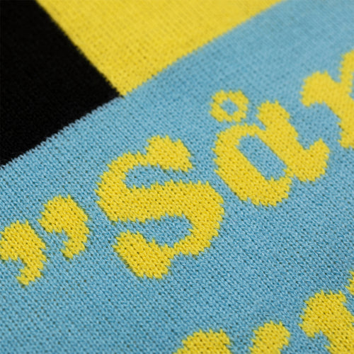 Close-up of a blue knitted Christmas sweater with yellow 