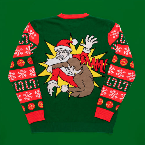 Grön stickad jultröja med motiv av en arg tomte och mönstrade ärmar från Svenskhusman.