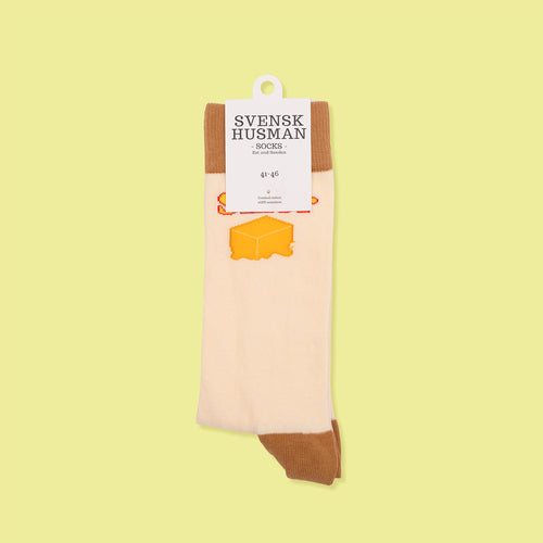 Beige strumpor med mönster av gula smörpaket och bruna detaljer från Svenskhusman.