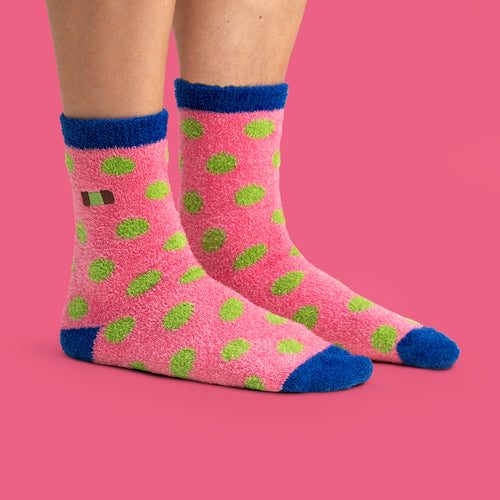 Pink fluffy socks with green dammsugare patterns and blue details from Svenskhusman.