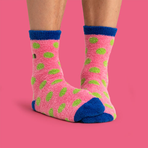 Fluffy pink socks with green dammsugare punsch roll patterns and blue details from Svenskhusman.