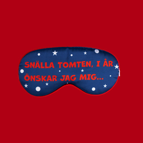 Mjuk mörkblå sovmask med stjärnmotiv och texten Snälla tomten från Svenskhusman.