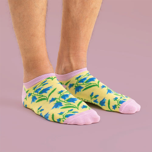 Sneakersstrumpor med mönster av blåklockor och rosa detaljer på fötter, från Svenskhusman.