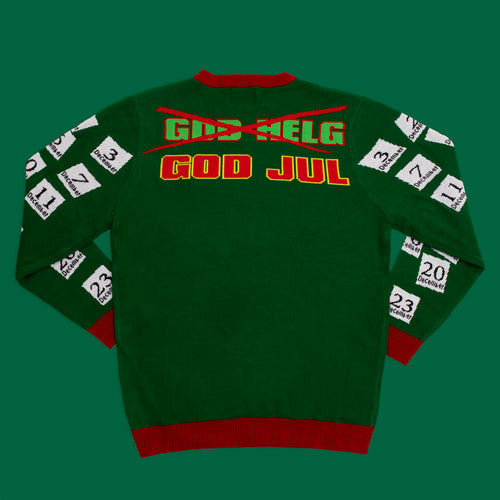 Grön stickad jultröja för dam med texten God Jul och ett körschema på ärmarna från Svenskhusman.