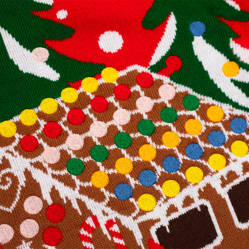 Knitted gingerbread house pattern with colorful dots on a festive Svenskhusman Christmas sweater.