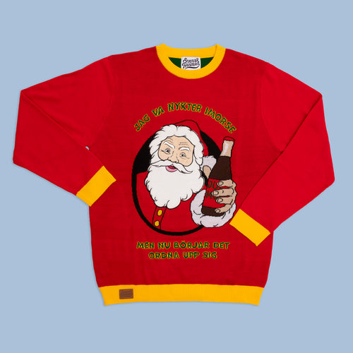 Röd jultröja med gula detaljer och tomtemotiv med texten Jag va nykter i morse från Svenskhusman.