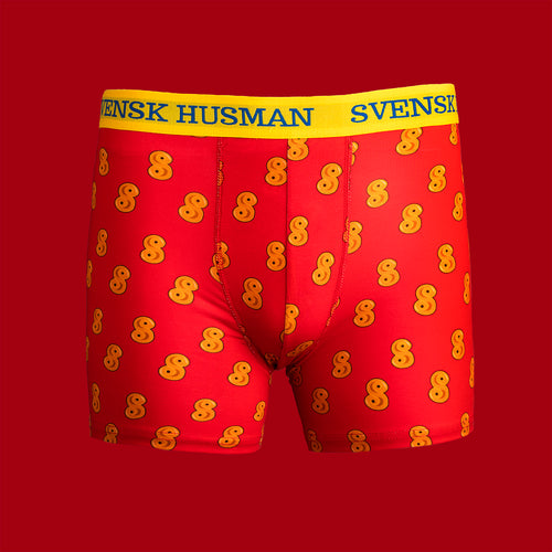 Röda boxerkalsonger med mönster av gula lussebullar och gult resårband från Svenskhusman.