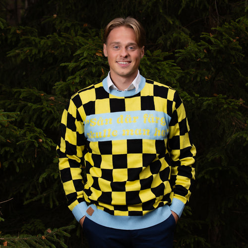 Yellow and black checkered Christmas sweater with the text 