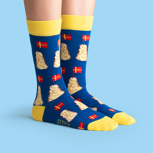 Blue and yellow socks featuring a pattern of spettekaka and Swedish flags from Svenskhusman.