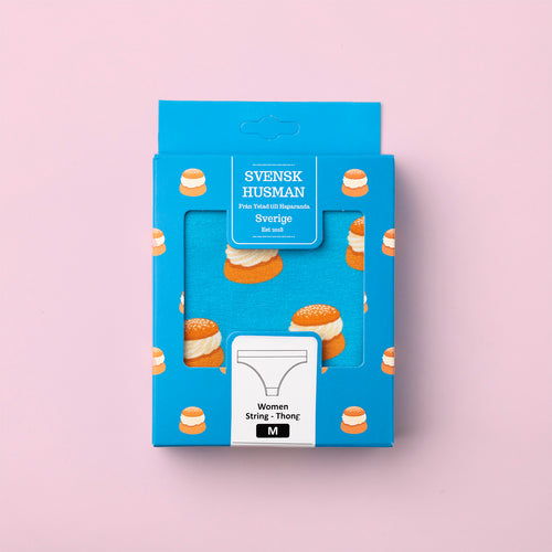 Blue Svenskhusman packaging for Semlan thong panties with a Swedish cream bun pattern on a pink background.